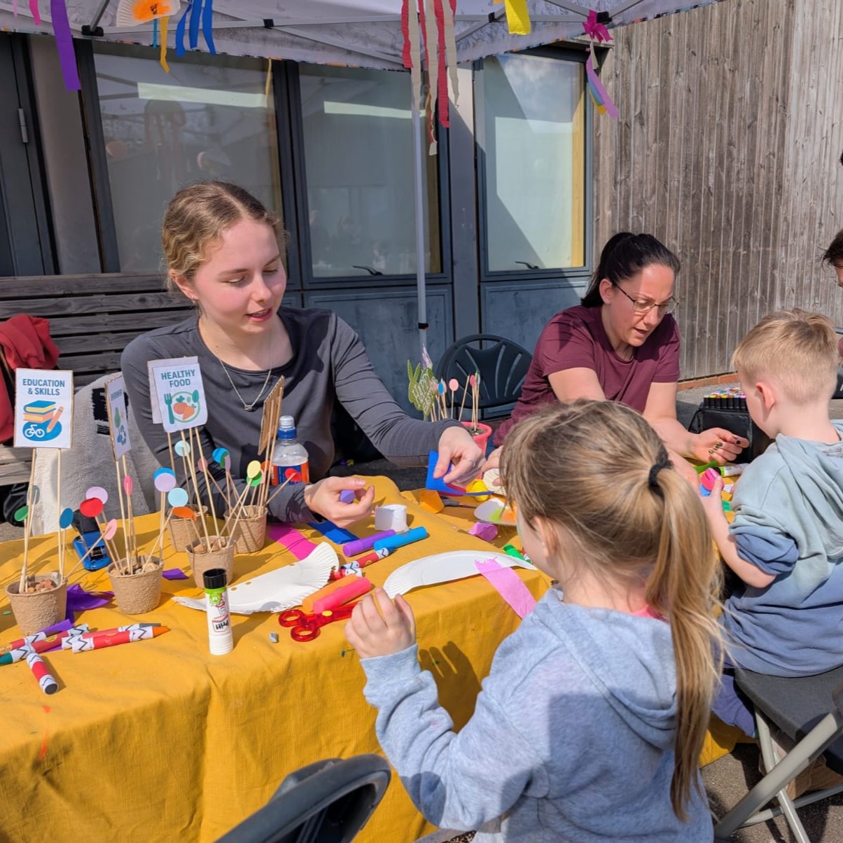 A group of children crafting with support of HIVE staff at an HDRC event