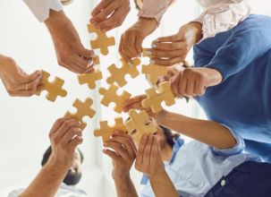 picture of people holding puzzle pieces